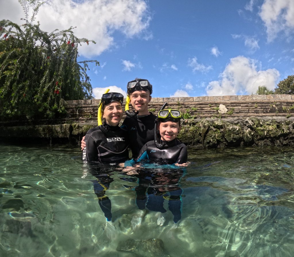 photo of Megan and her kids, snorkeling with manatees 